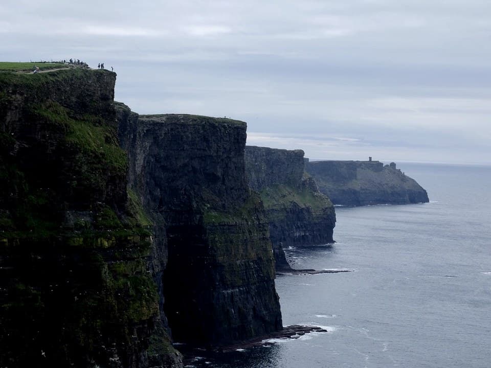 Cliffs of Moher with hikers at the edge