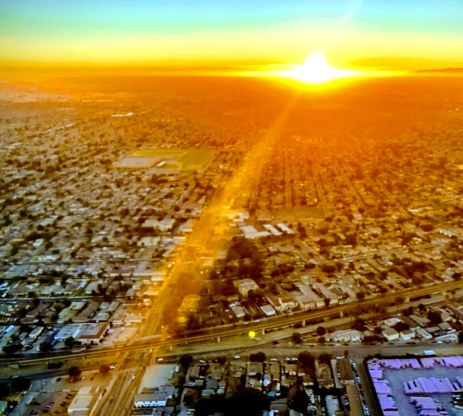 LA suburbia at sunset, helicopter view