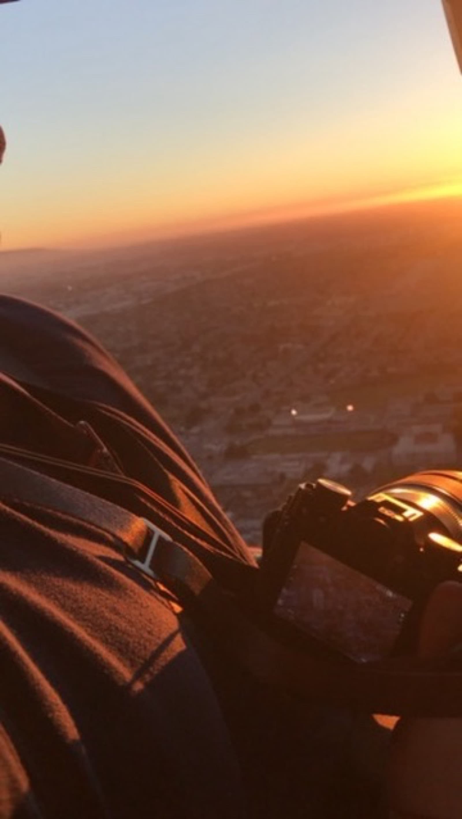 Camera in hand, helicopter window view